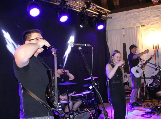 Die Musiker stoßen mit dem Publikum an